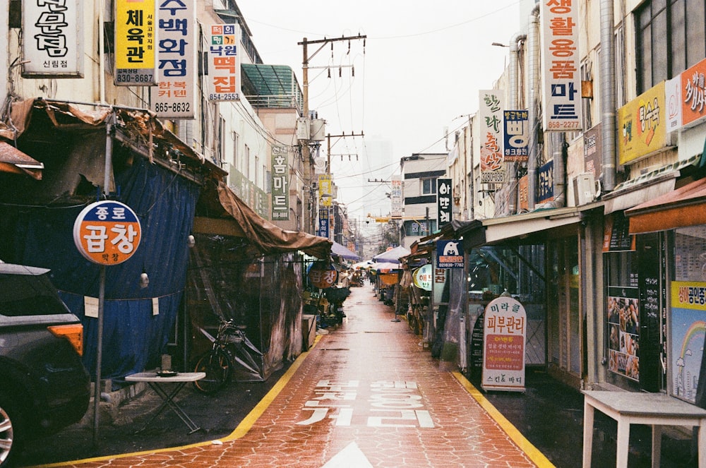 people walking on sidewalk between buildings during daytime