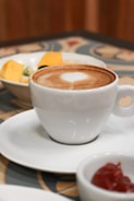 white ceramic cup with brown liquid inside