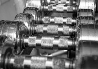 silver dumbbells on brown wooden table