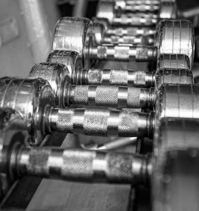 silver dumbbells on brown wooden table
