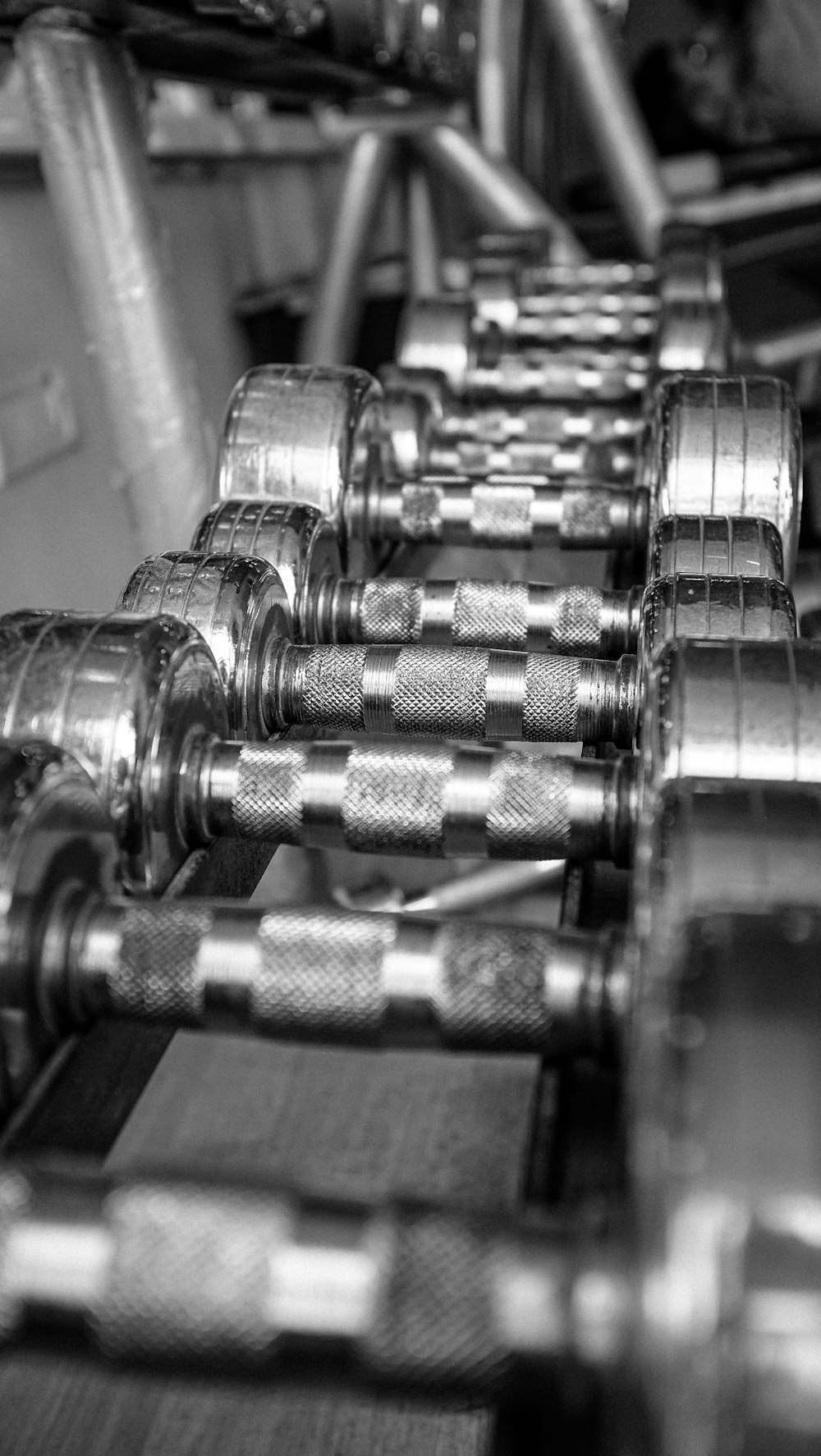 silver dumbbells on brown wooden table