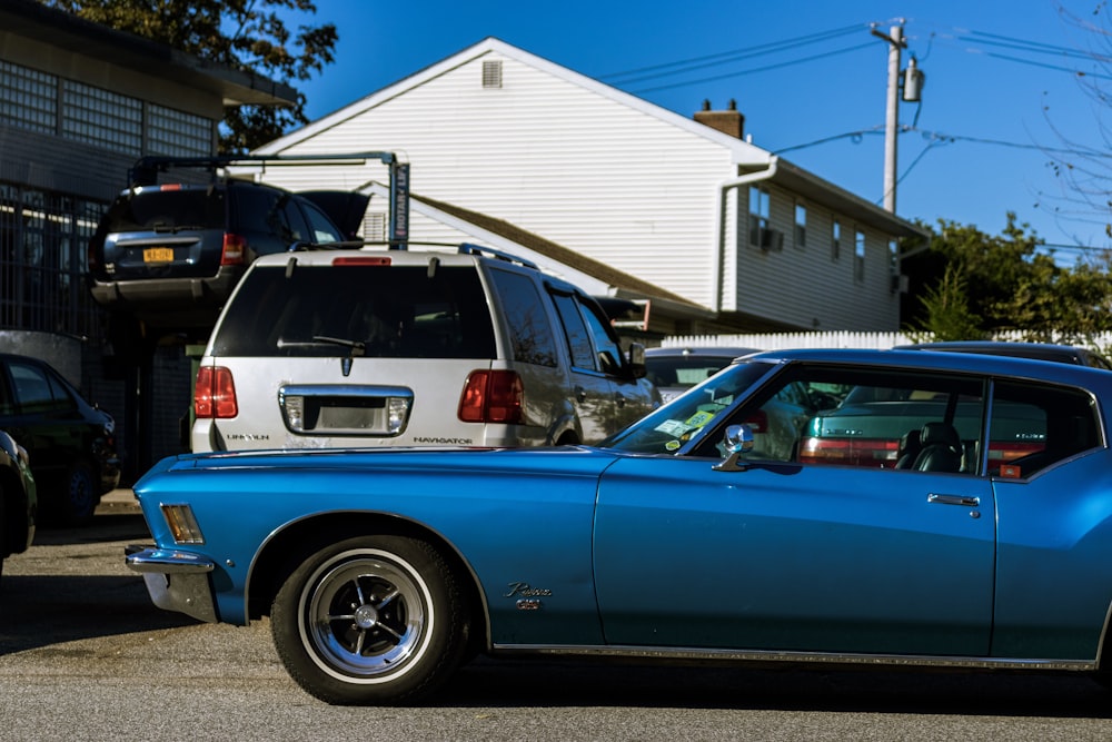 blue car parked near white building