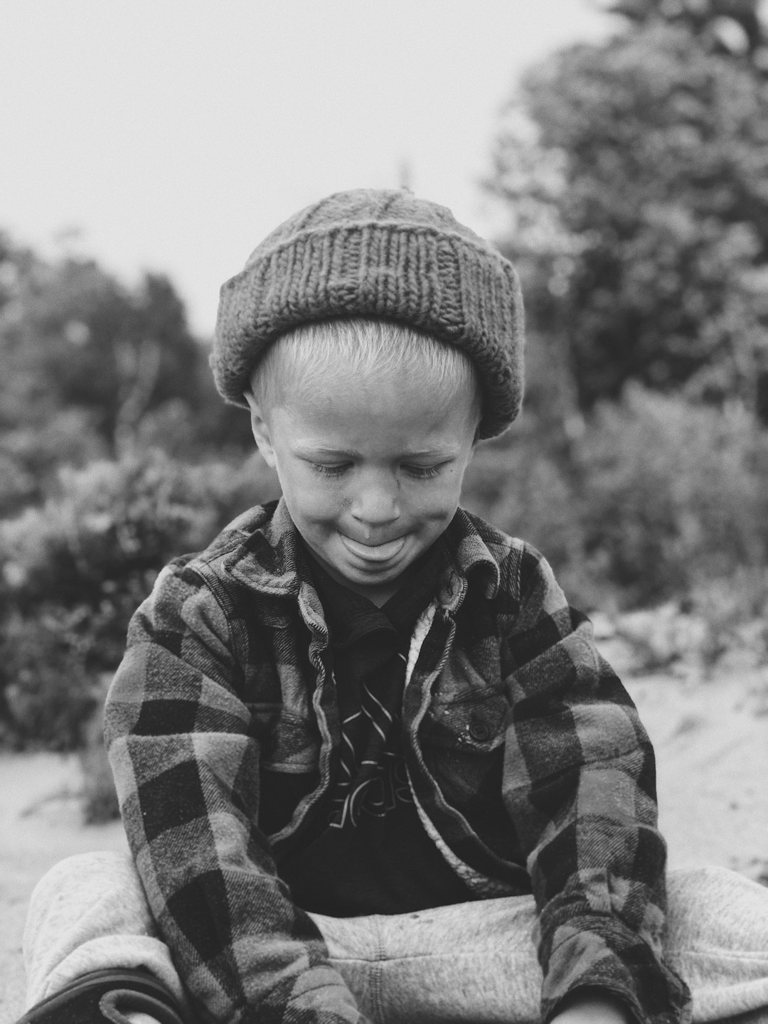 grayscale photo of boy in jacket and knit cap