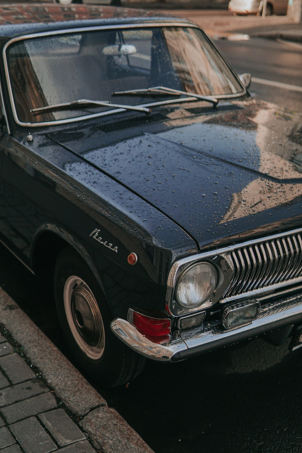 black car on gray asphalt road during daytime