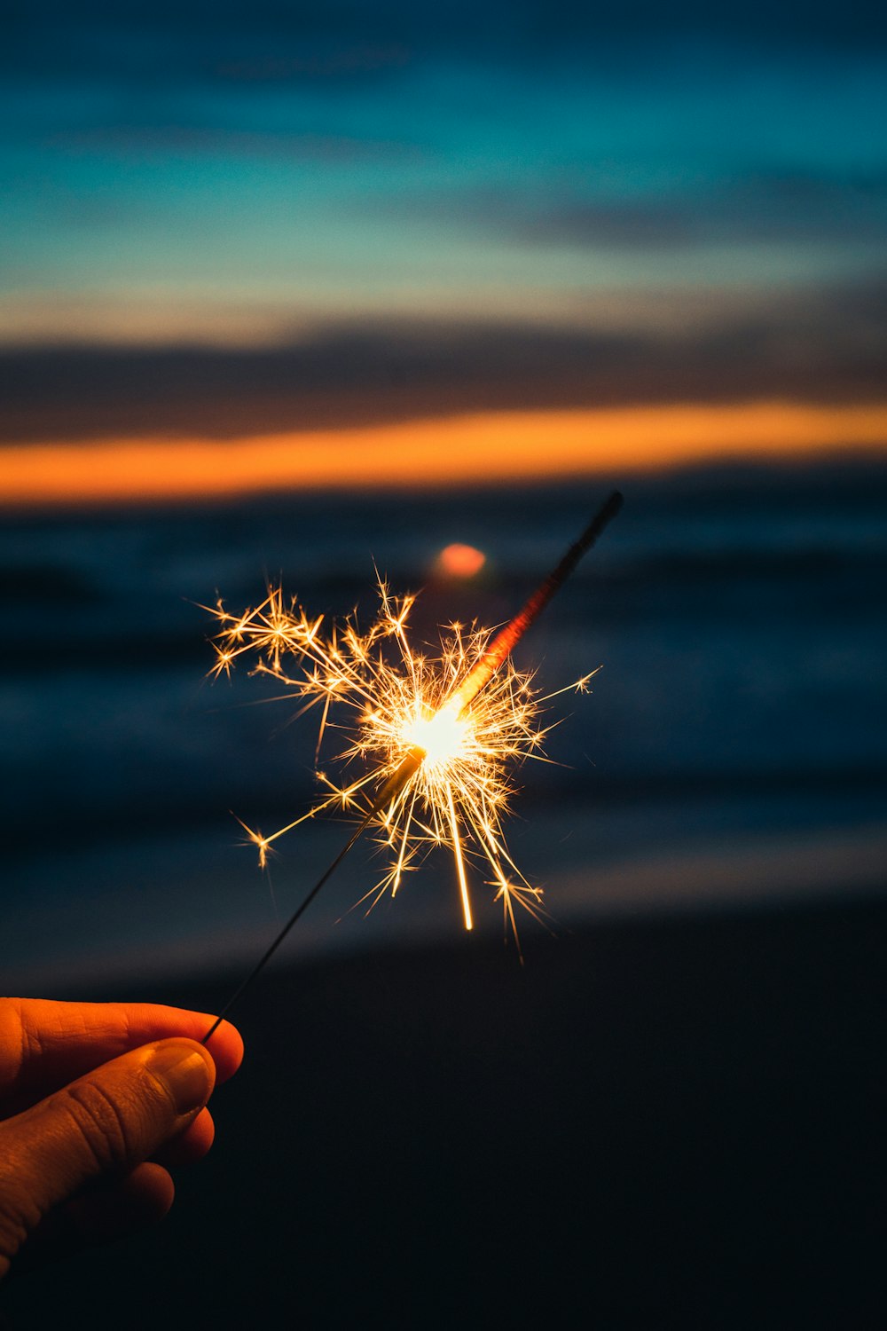 person holding sparkler during night time