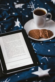 An open ebook on a laptop with a coffee cup beside it, symbolizing learning and growth.