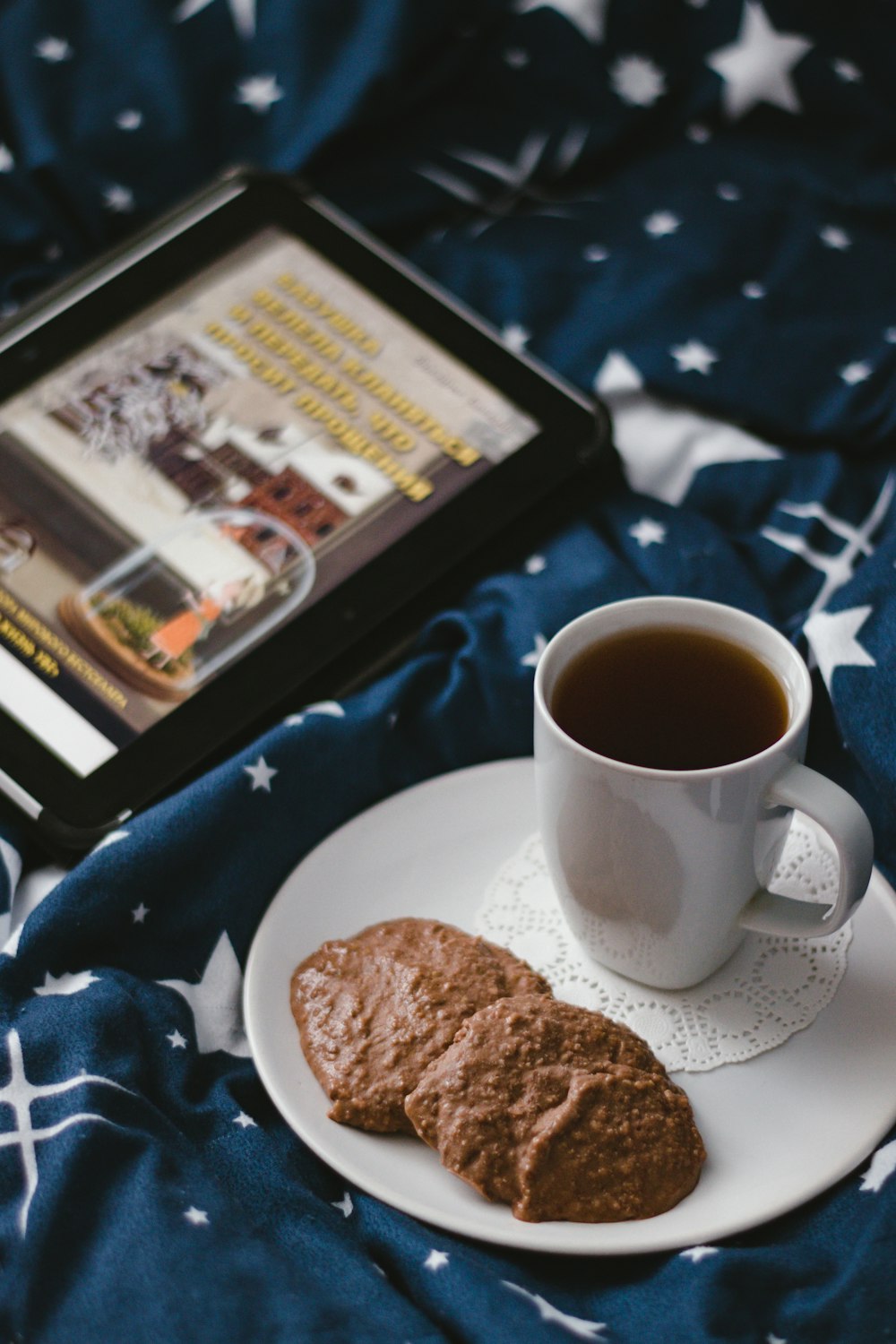 white ceramic mug beside brown bread on black tray