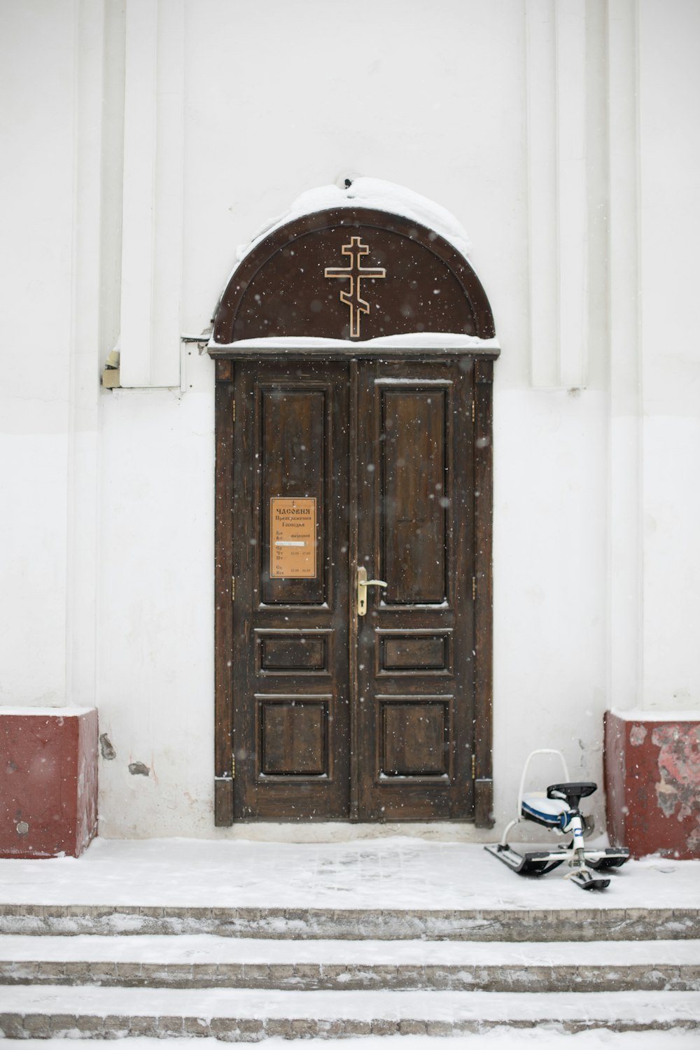 brown wooden door with cross