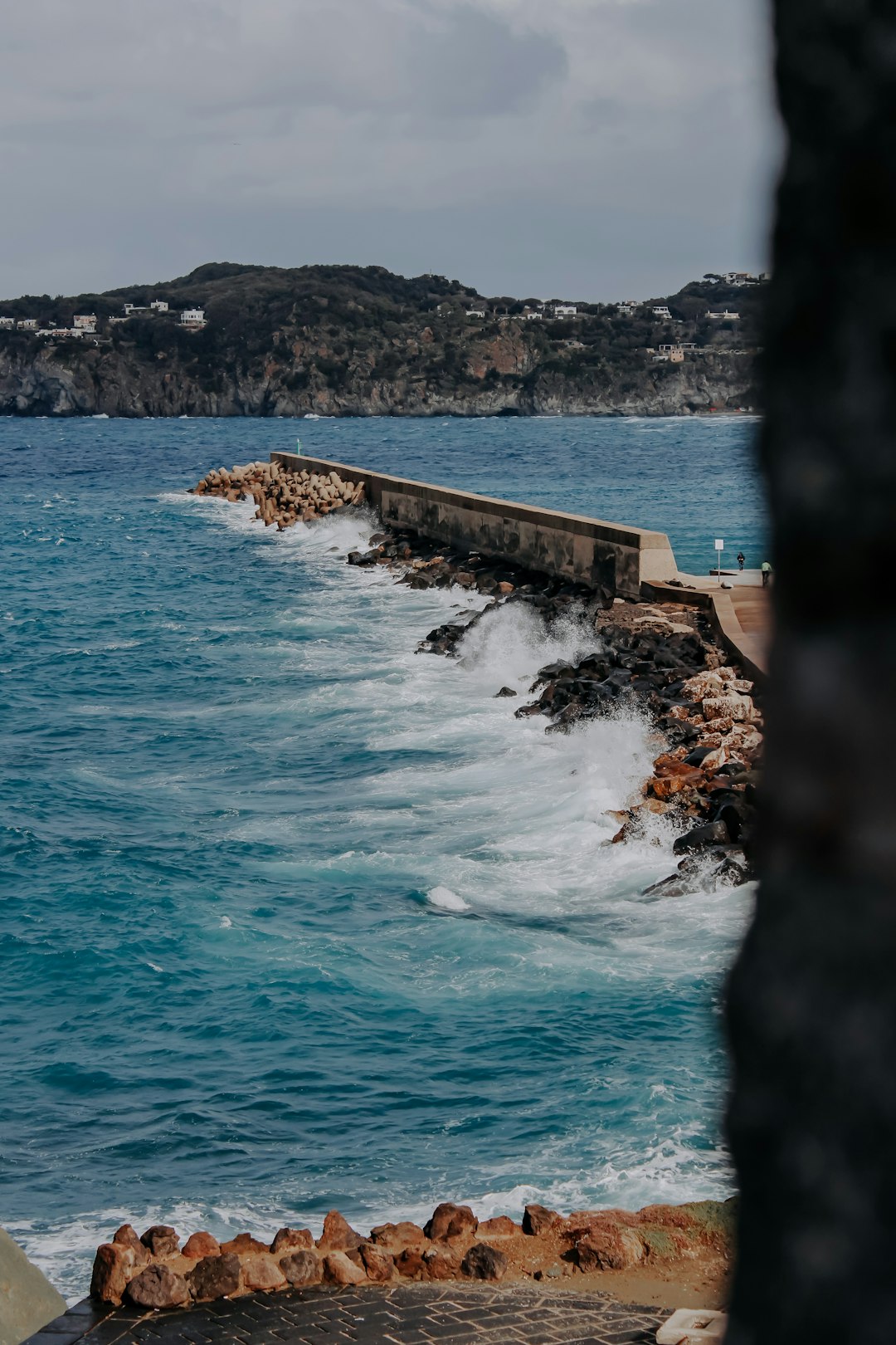 ocean waves crashing on brown concrete wall during daytime