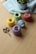 Close-up of colorful yarn balls and crochet hooks arranged neatly on a wooden table.