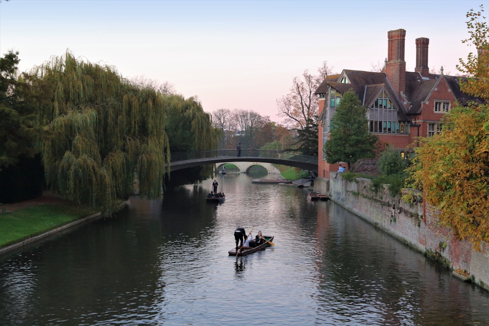 man riding on boat on river during daytime