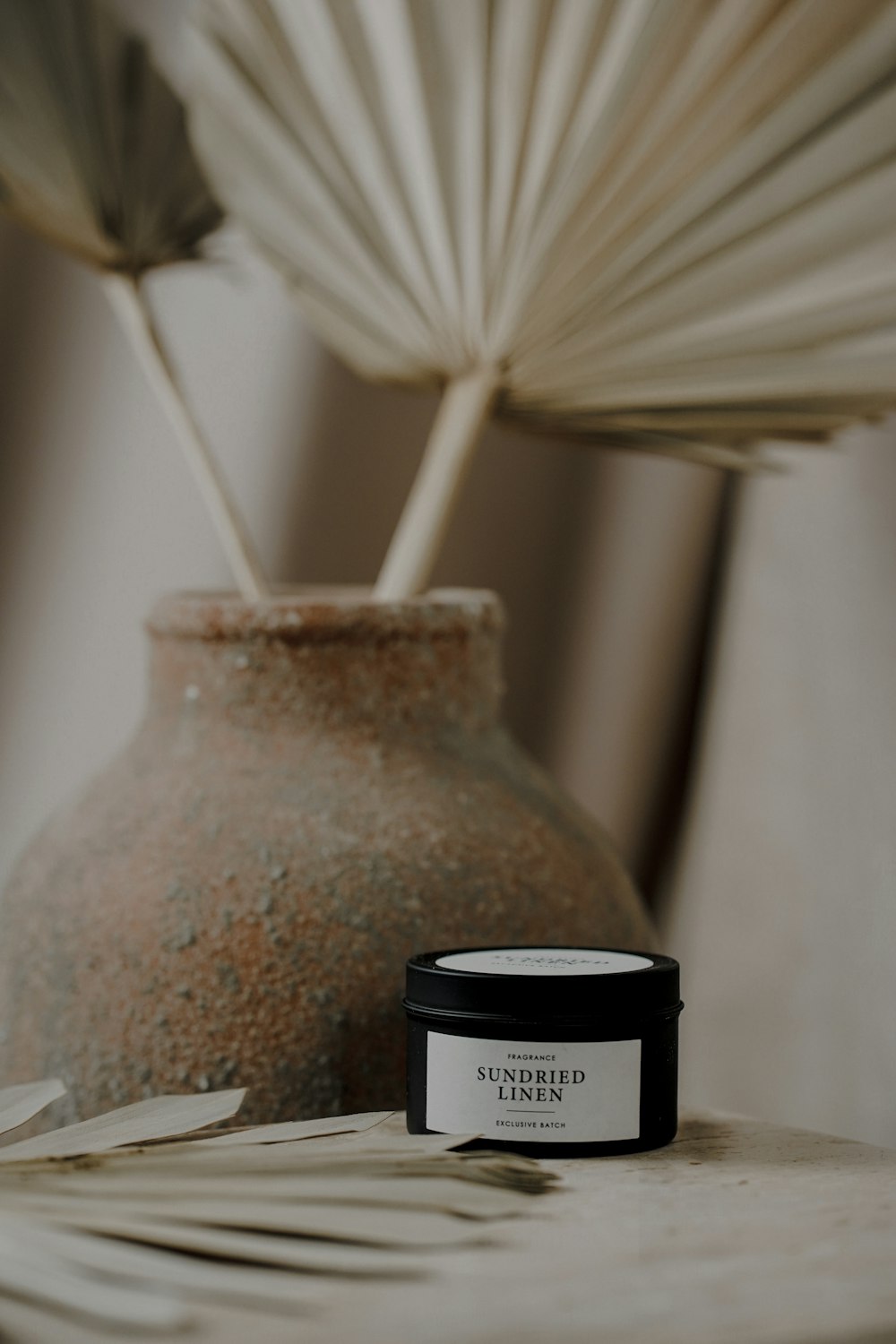 white feather on black and white ceramic jar