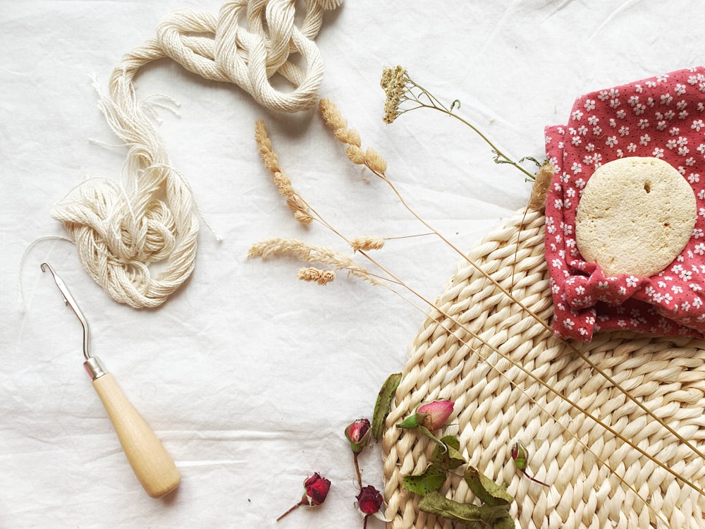 white and red flower on brown woven basket