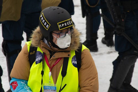 woman in yellow jacket wearing black helmet