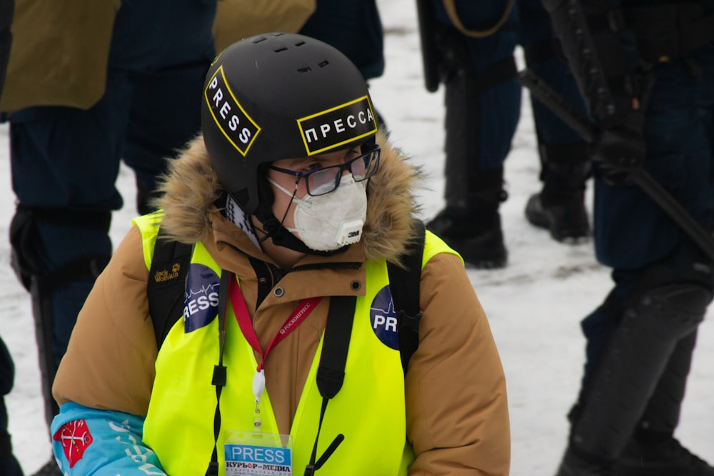 woman in yellow jacket wearing black helmet