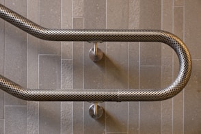 stainless steel pipe on gray wall