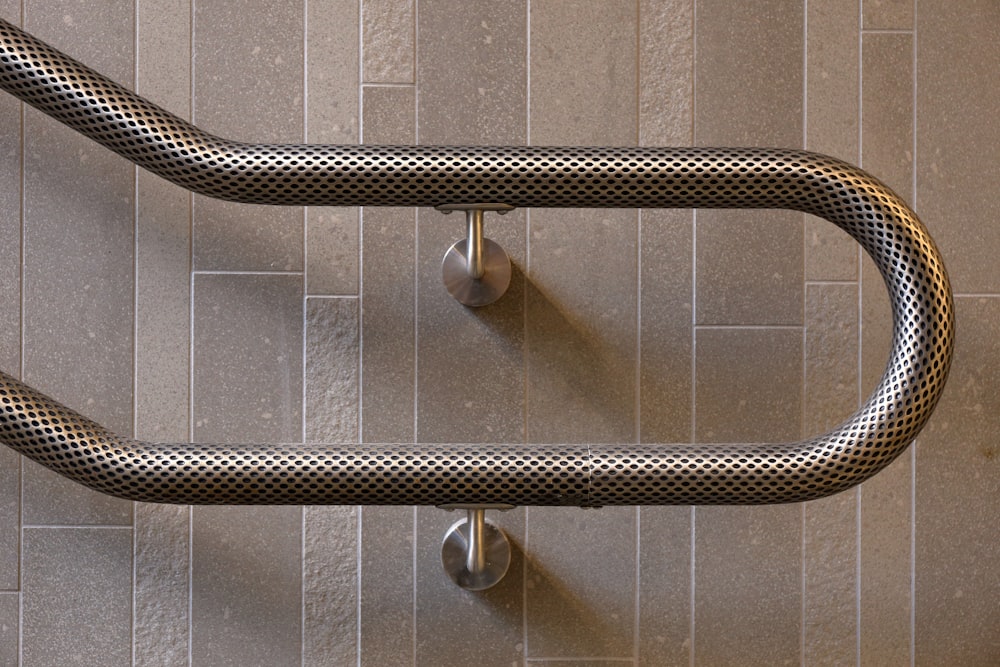 stainless steel pipe on gray wall