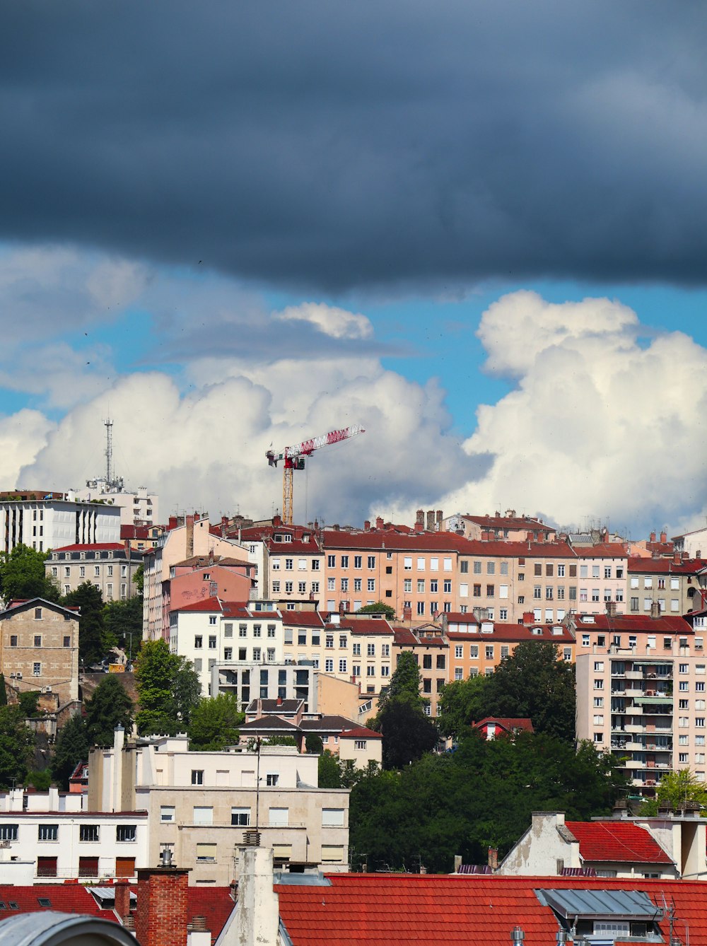 white and brown concrete buildings under blue sky and white clouds during daytime