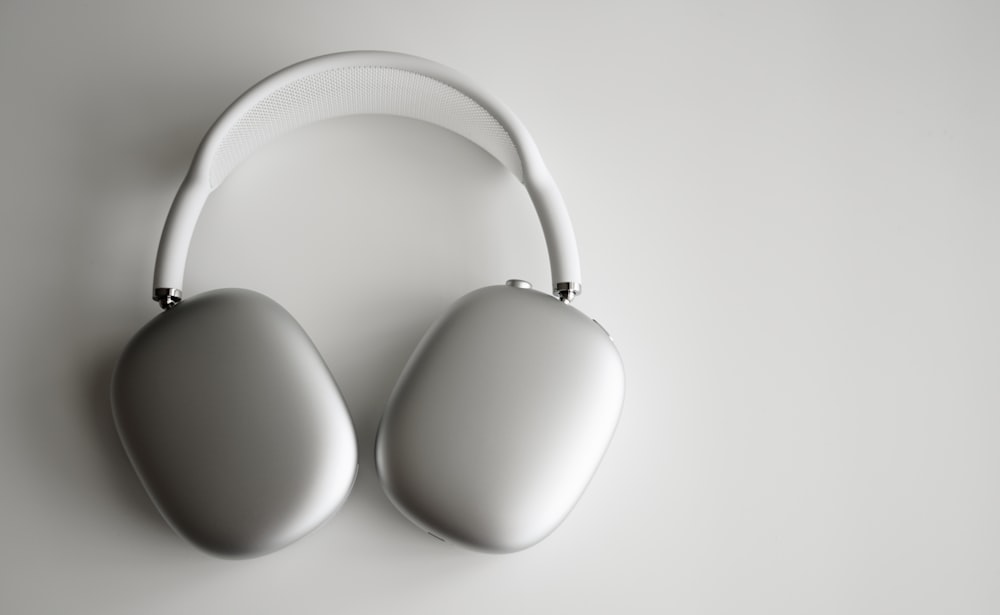 white wireless headphones on white table
