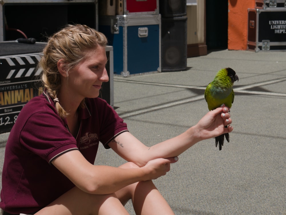 green bird on womans hand