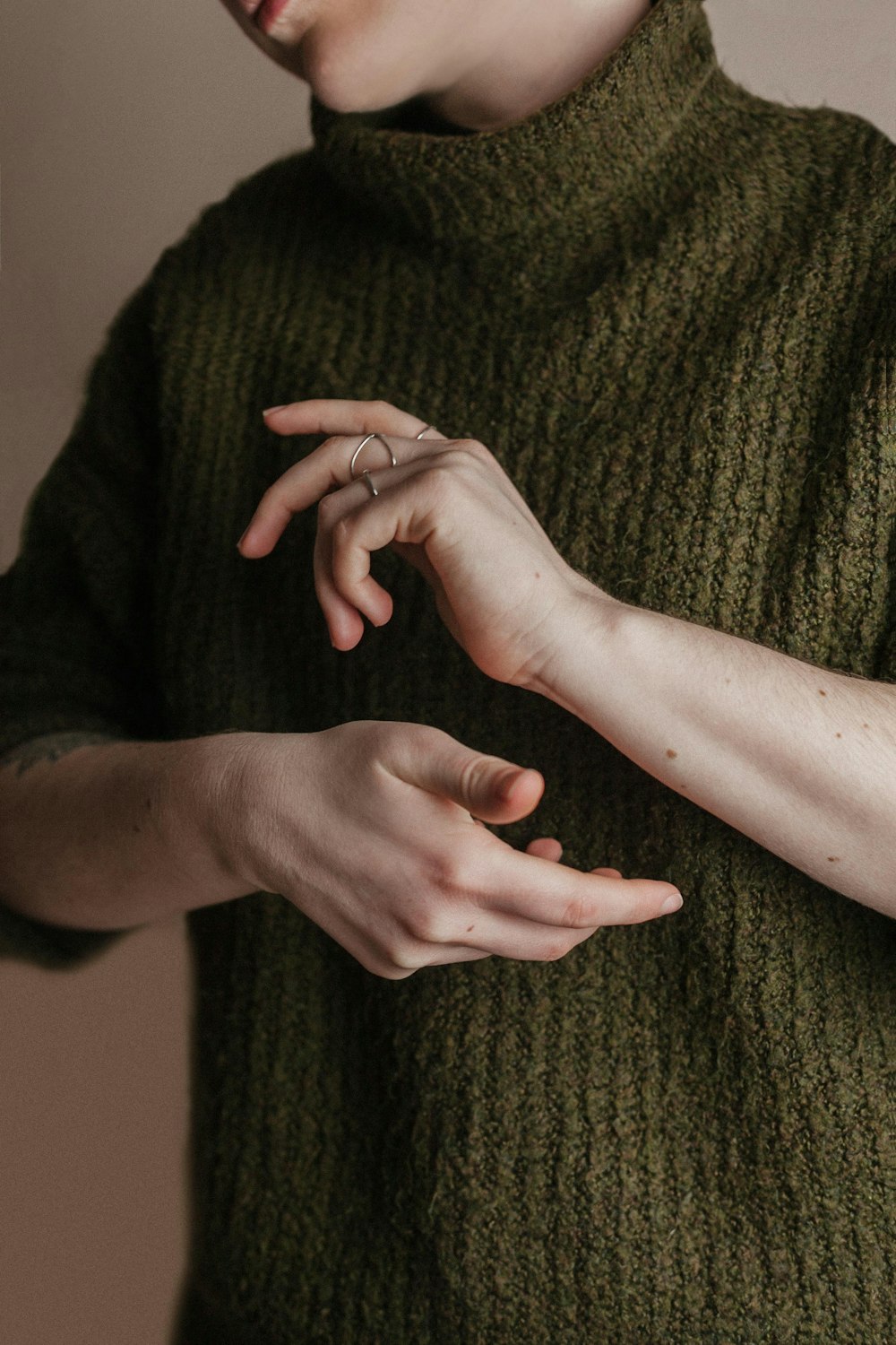 persons left hand on green textile