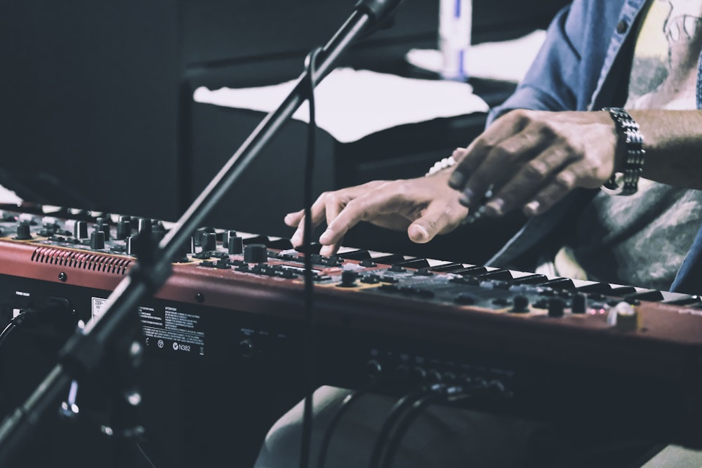 person playing audio mixer in front of microphone