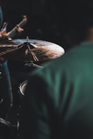 Close-up of drum cymbals catching the light during an energetic performance.