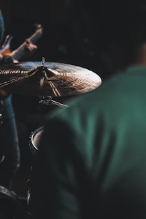 Close-up of drum cymbals catching the light during an energetic performance.