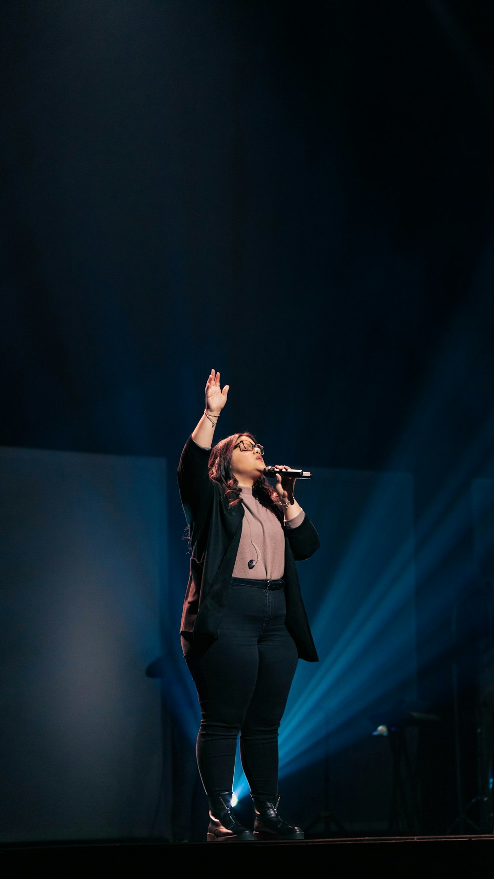 woman in black blazer singing