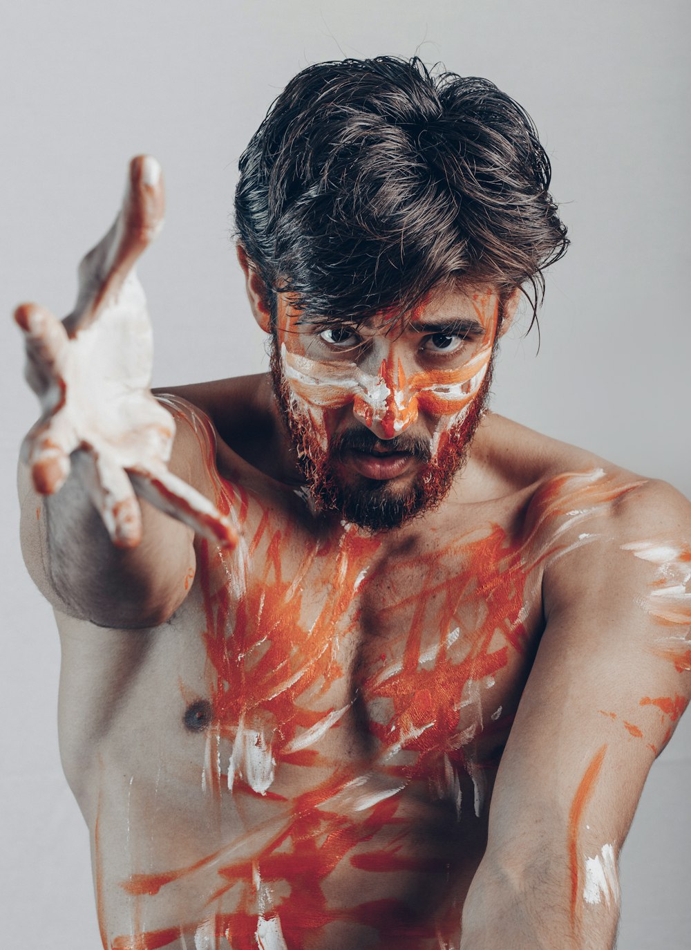 topless man with red paint on face