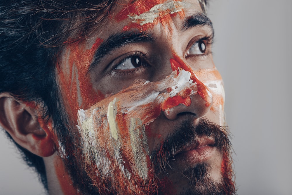 man with white and red face paint