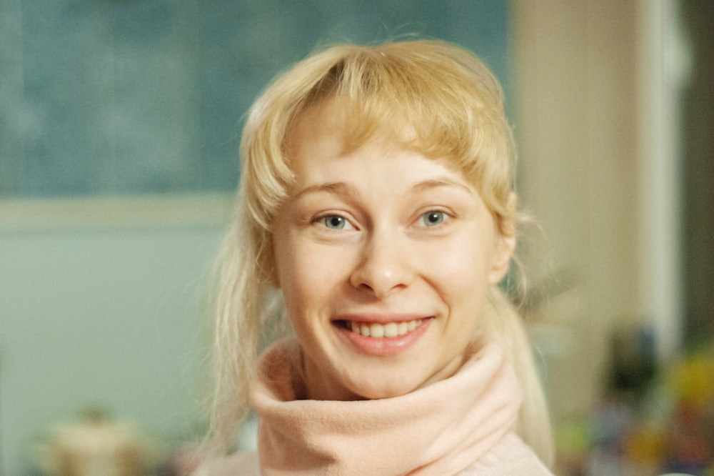 smiling blonde girl wearing white scarf