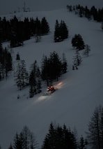 A snowplow working through the scenic Burke Mountain area on a snowy morning.