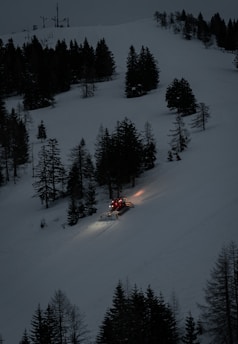 A snowplow working through the scenic Burke Mountain area on a snowy morning.