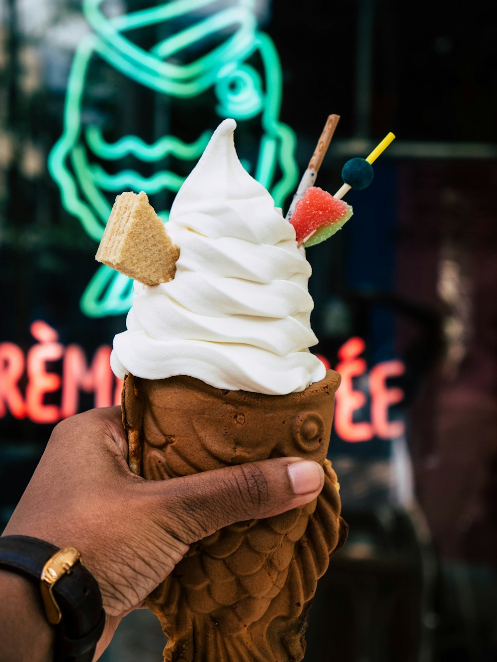 person holding ice cream cone with white ice cream