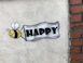 a sign that says happy with a bee on it
