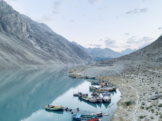 a group of boats floating on top of a lake