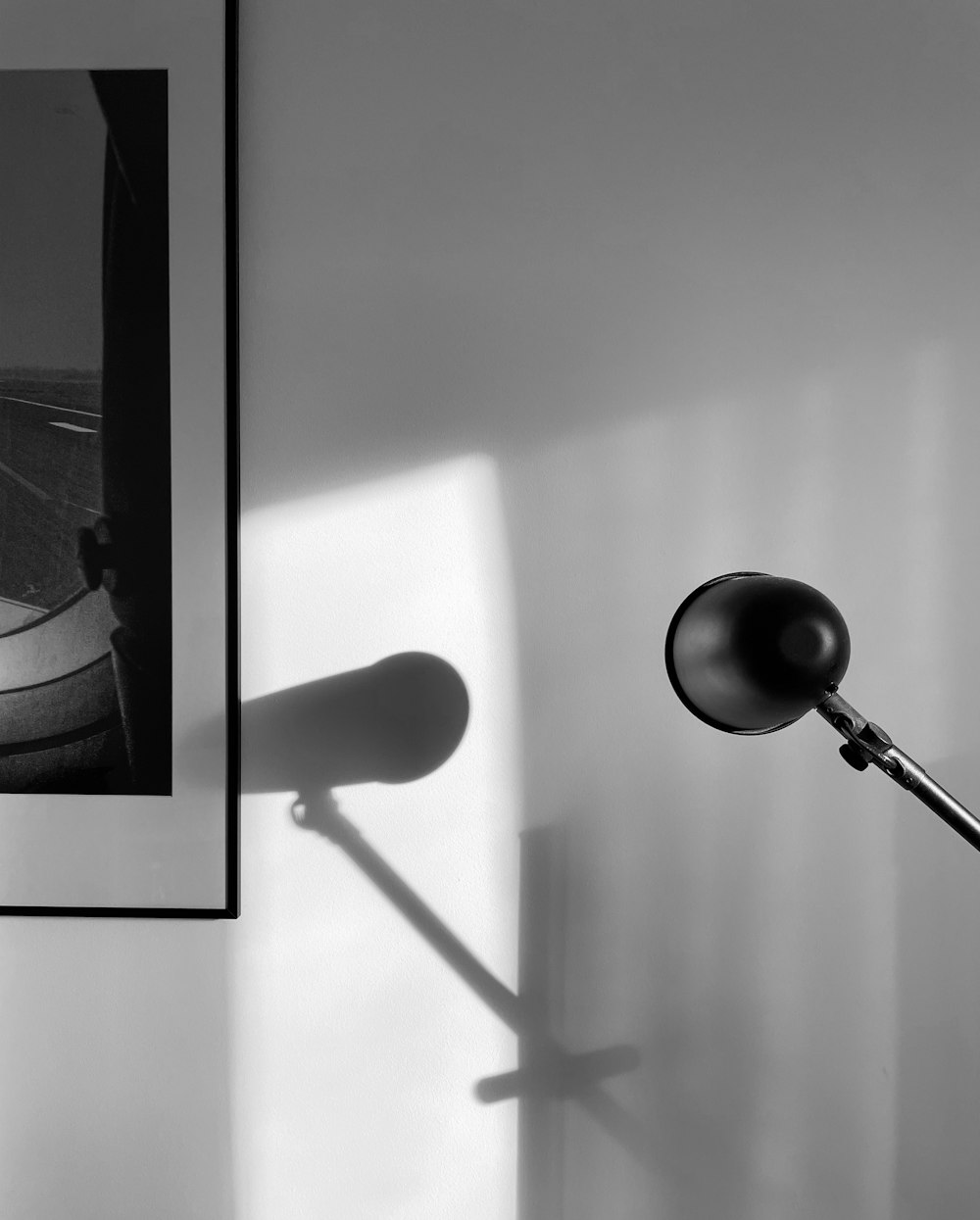 grayscale photo of torchiere lamp