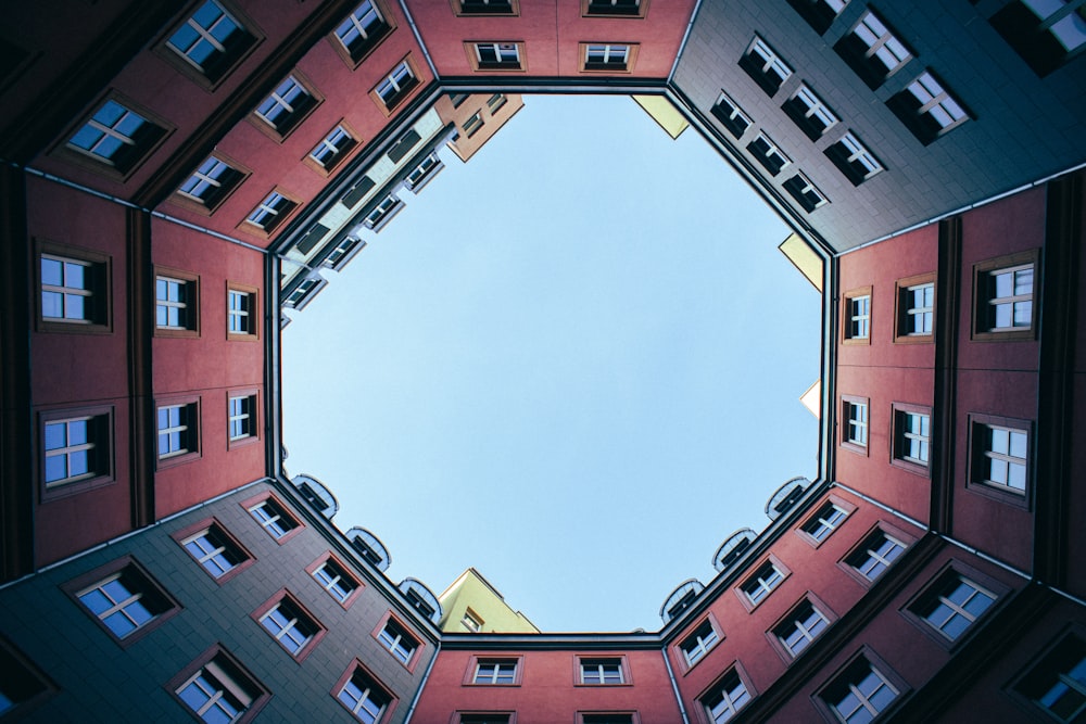 brown and white concrete building under white clouds during daytime