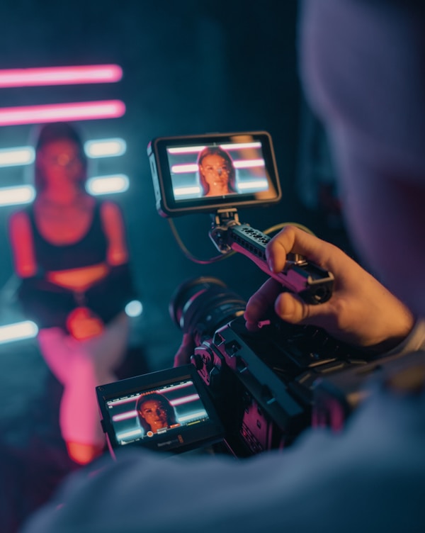 person holding black smartphone taking photo of man in black shirt