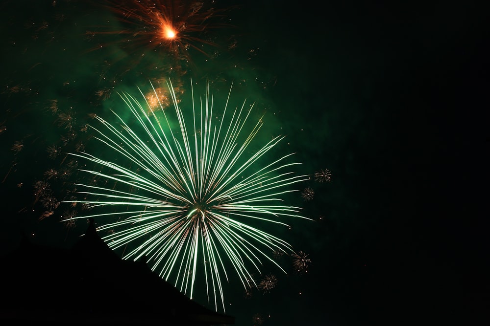 green and yellow fireworks during nighttime