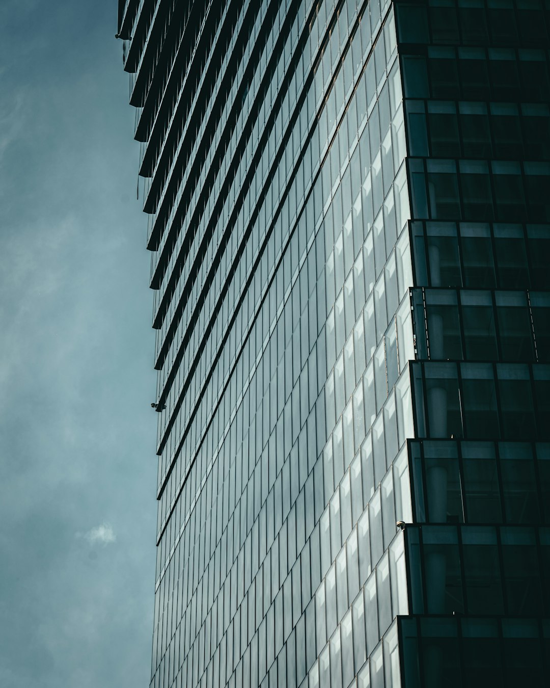 gray concrete building under cloudy sky during daytime