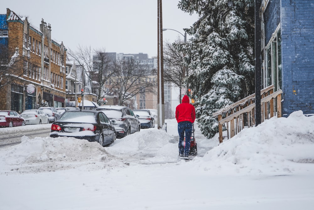 person in blue jacket standing on snow covered ground during daytime