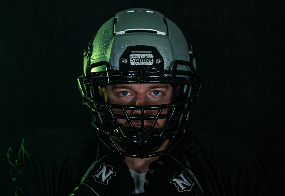 green and black helmet on black textile