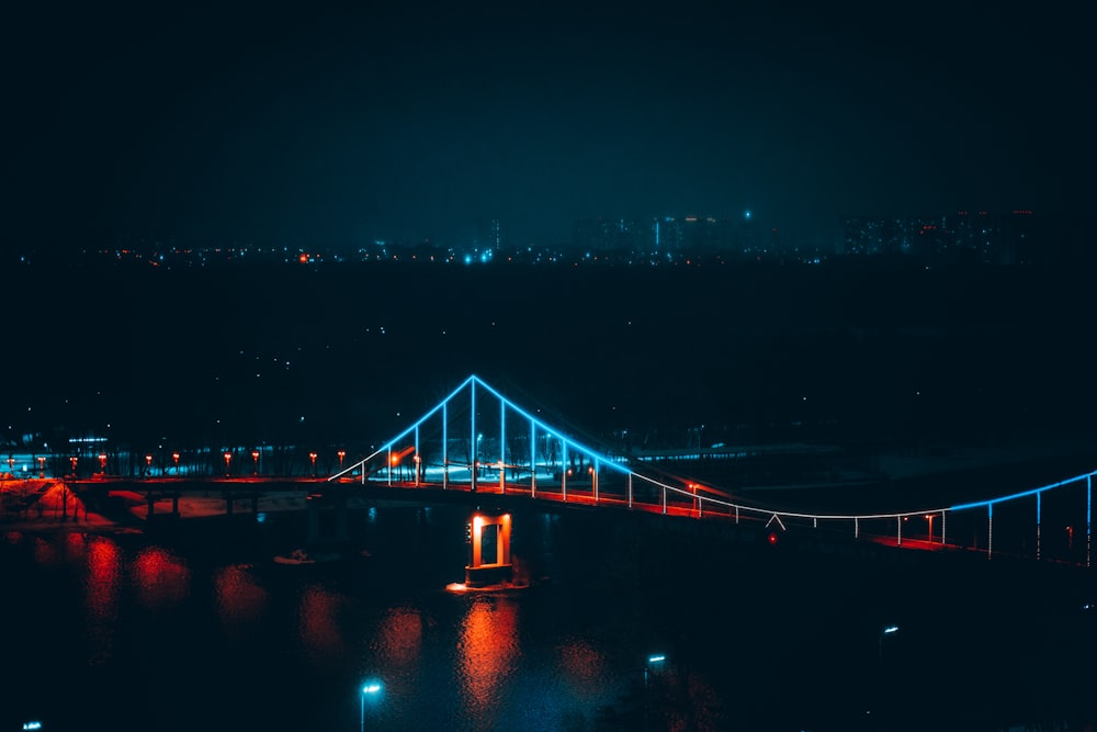 lighted bridge over water during night time