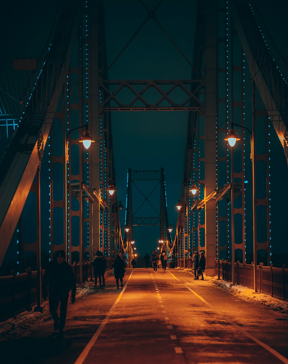 people walking on bridge during night time