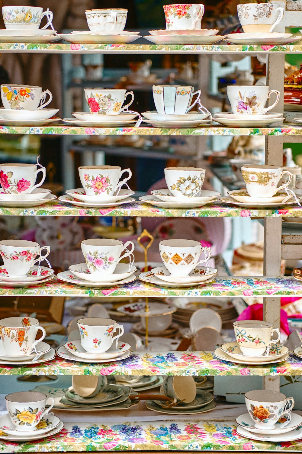 white ceramic teacup set on brown wooden shelf