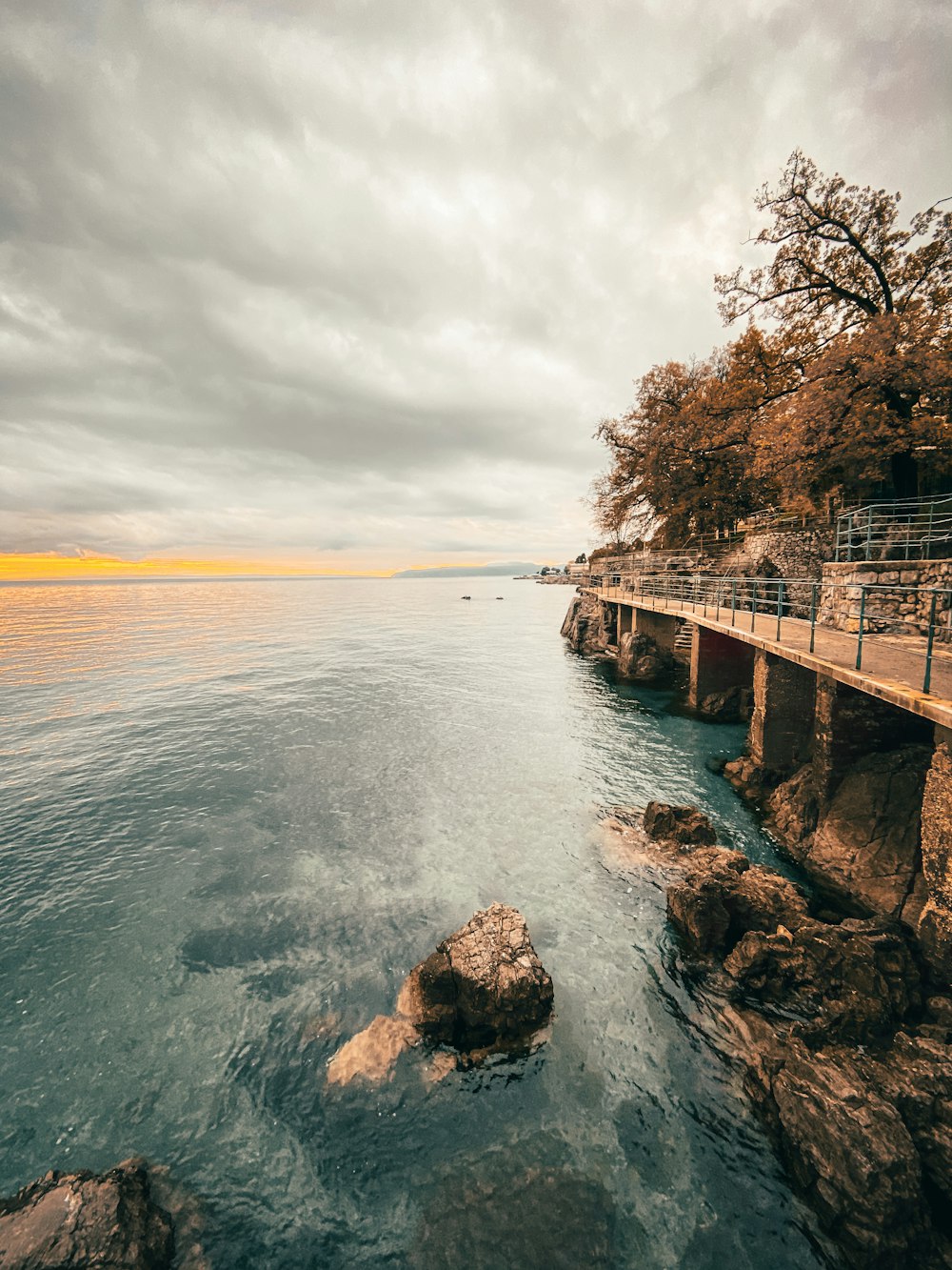 brown wooden dock on body of water during daytime