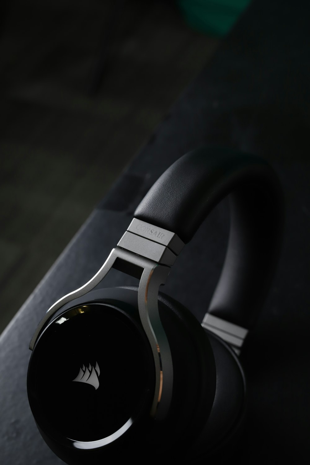 black and silver headphones on black surface