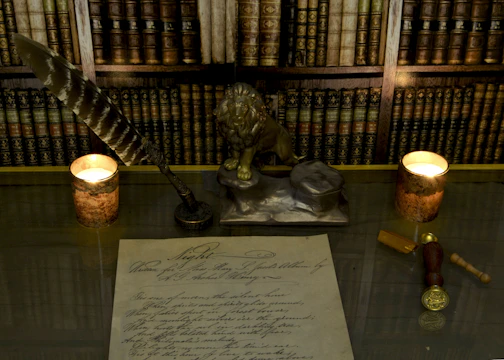 Elegant office desk with gold accents, an open notebook, and INPI documents with a crimson wax seal.
